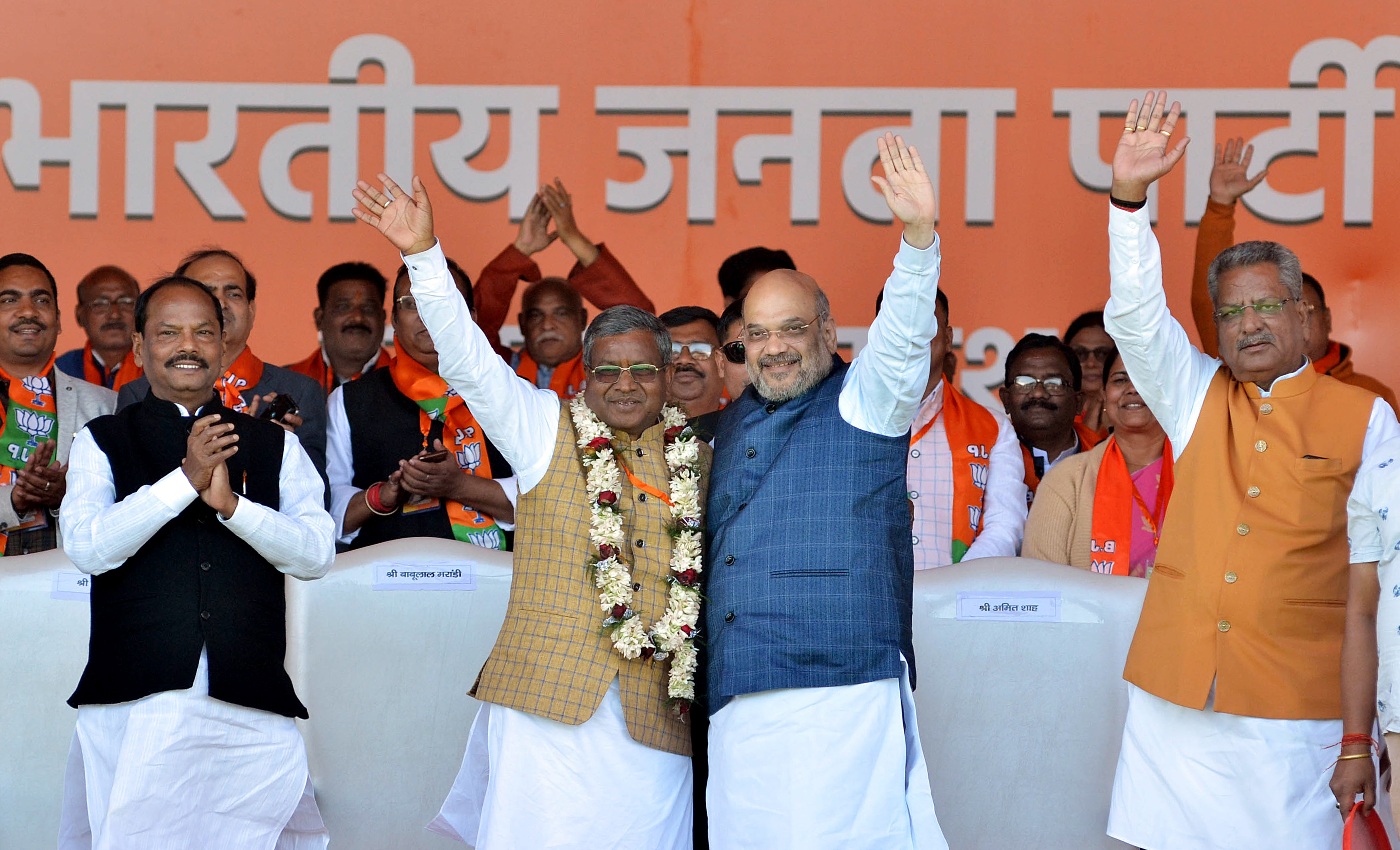 Union Home Minister Amit Shah along with Jharkhand Vikas Morcha (JVM-Prajatantrik) chief Babulal Marandi as he merged his JVM-P party with the BJP
