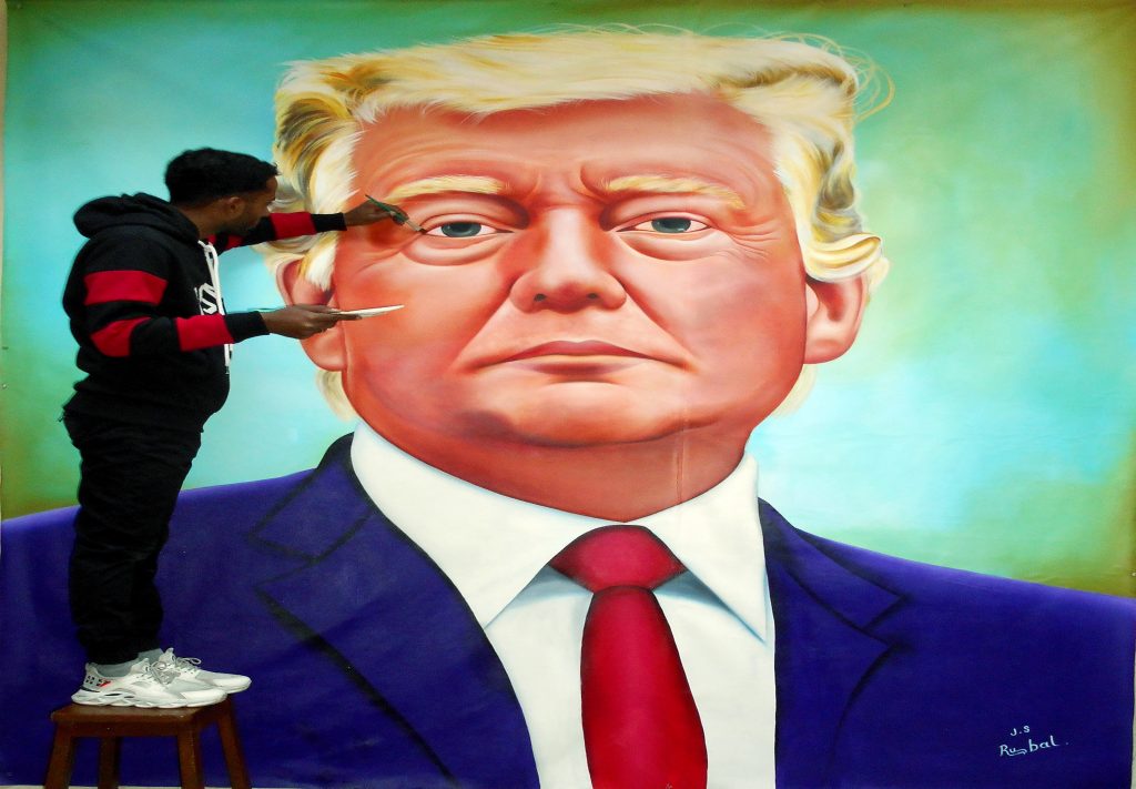 Jagjot Singh Rubal, an artist from Amritsar gives final touches to the painting of the US President Donald Trump