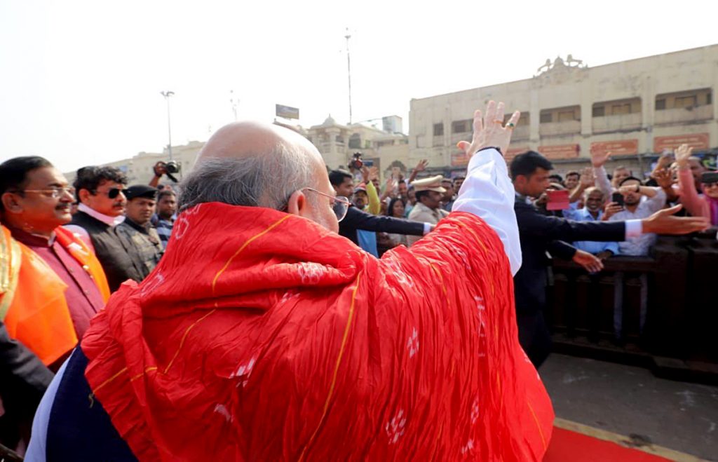 Home Minister Amit Shah waves to supporters during his visit to Jagannath temple