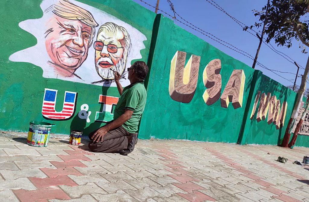 An artist makes graffiti showing a picture of USA President Donald Trump