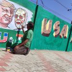 An artist makes graffiti showing a picture of USA President Donald Trump