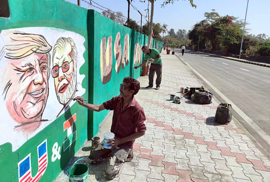 An artist makes graffiti showing a picture of USA President Donald Trump
