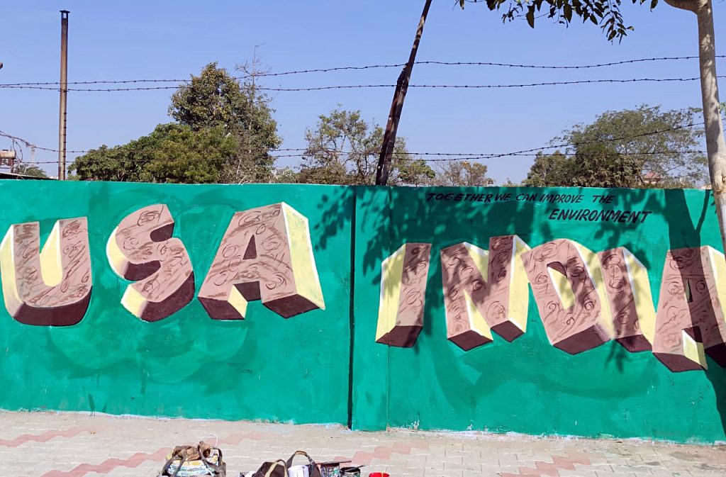 An artist makes graffiti showing a picture of USA President Donald Trump