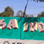 An artist makes graffiti showing a picture of USA President Donald Trump