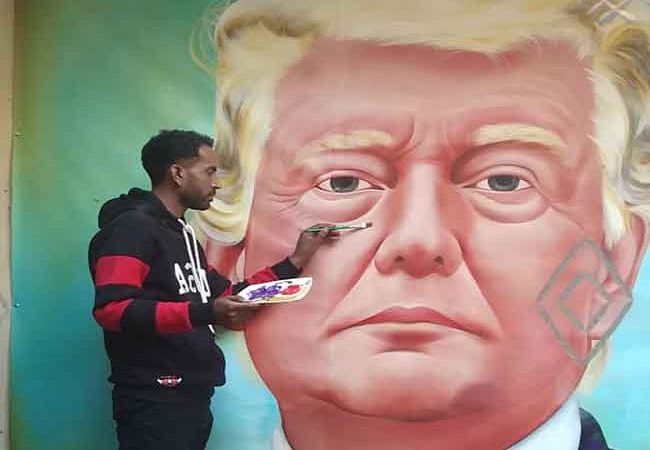 Jagjot Singh Rubal, an artist from Amritsar gives final touches to the painting of the US President Donald Trump